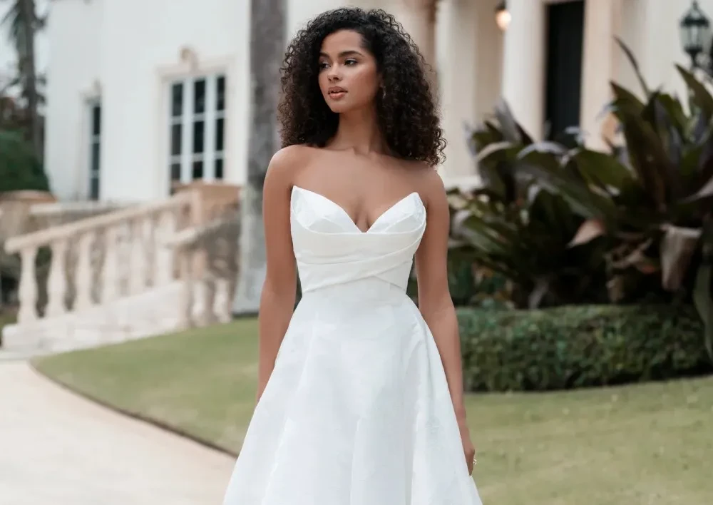 Model wearing a white gown by Allure