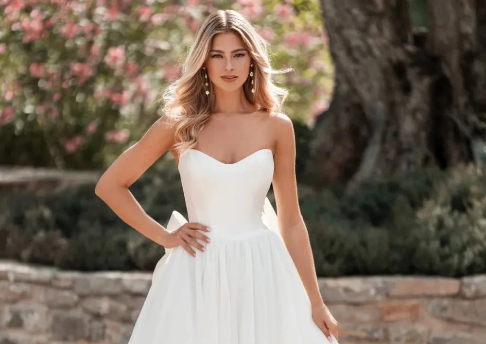 Model wearing a white gown by Allure