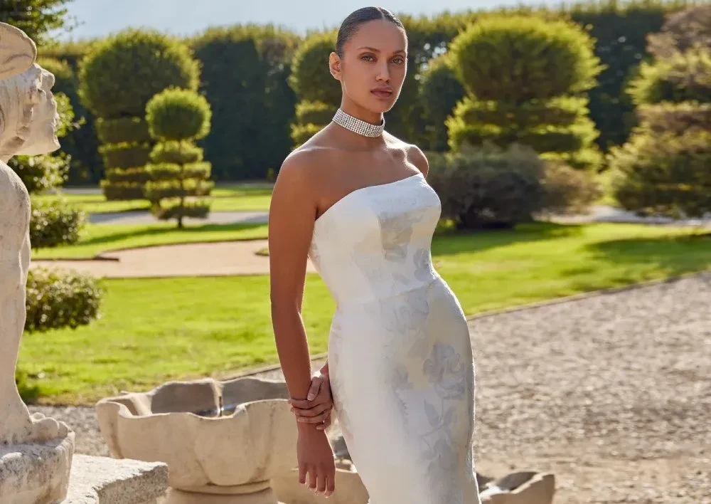 Model wearing a white gown by Justin Alexander