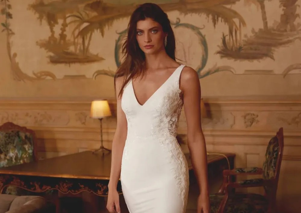 Model wearing a white gown by Justin Alexander