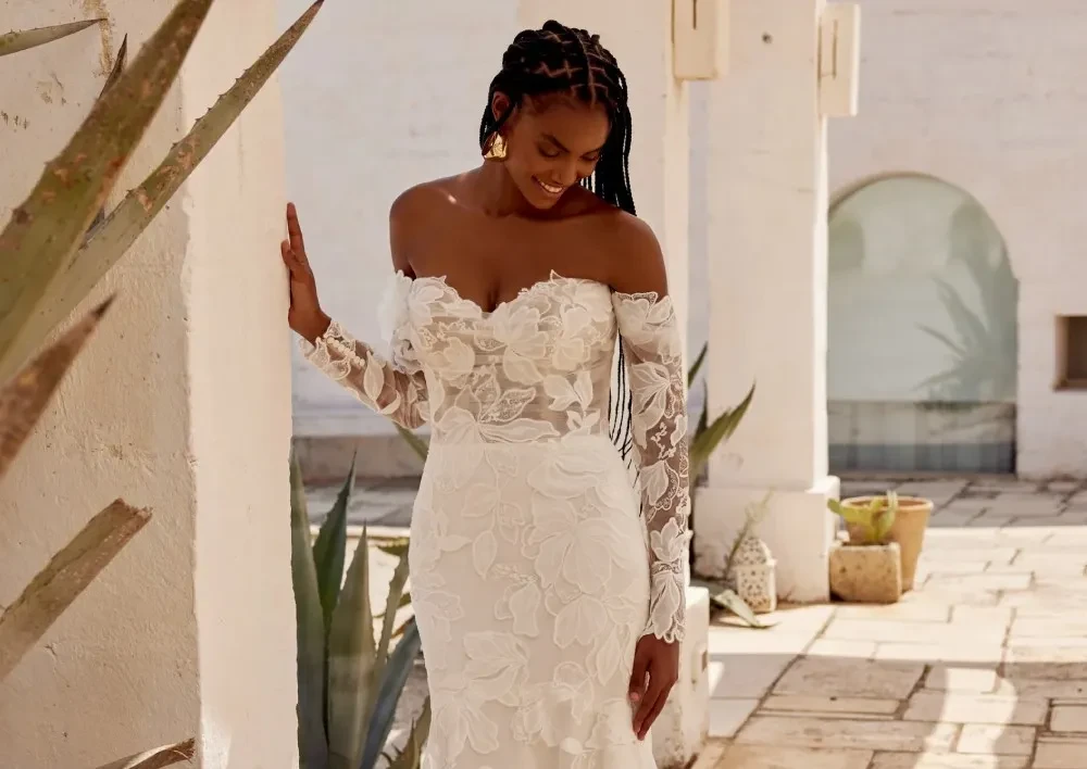 Model wearing a white gown by Lillian West
