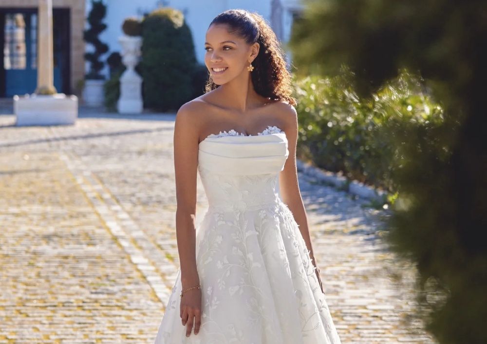 Model wearing a white gown by Lillian West