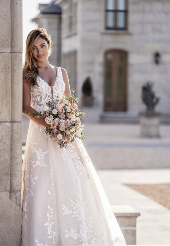 Model wearing a white gown by Allure