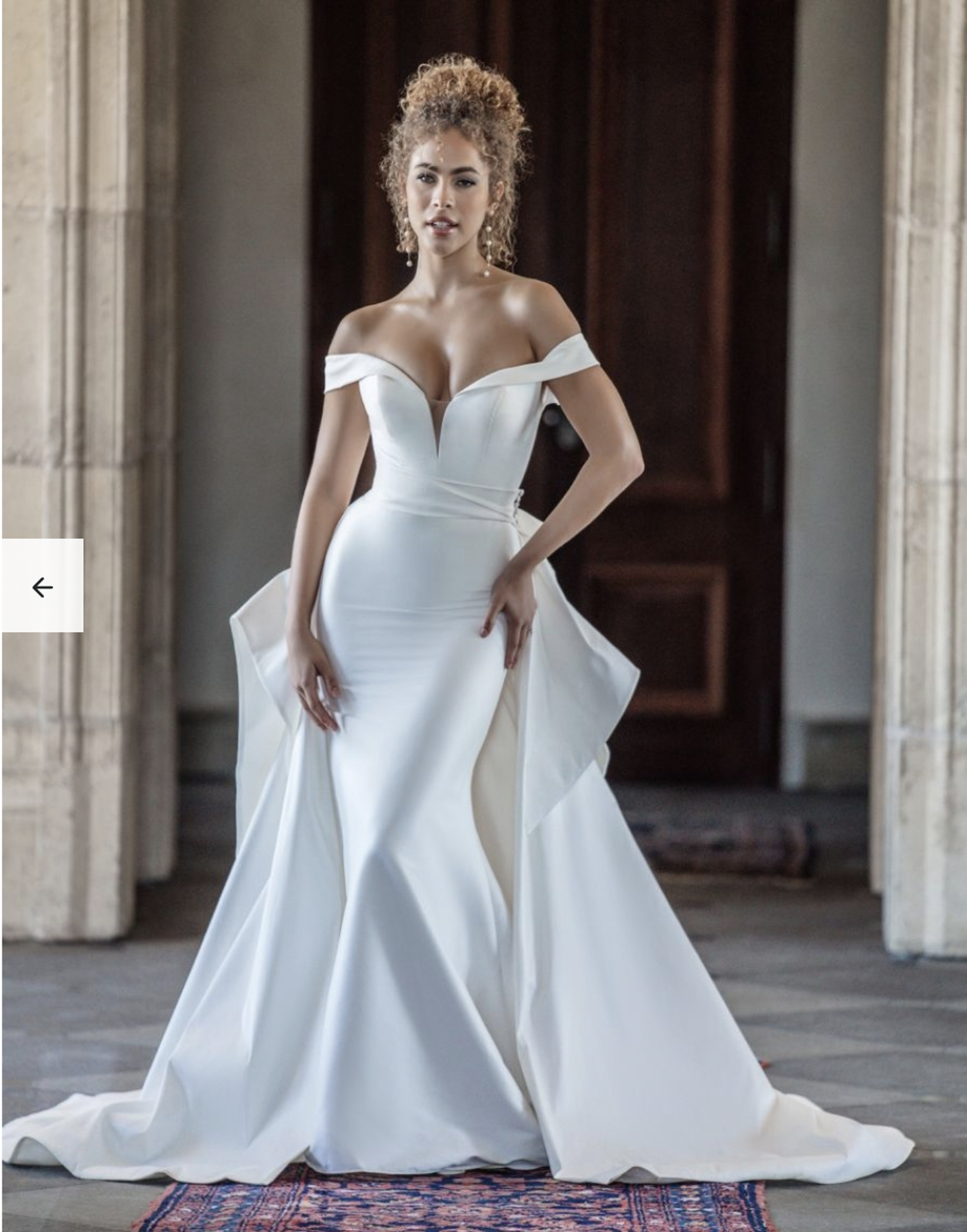 Brunette woman wearing a detachable stretch Mikado train wedding dress featuring a beautifully