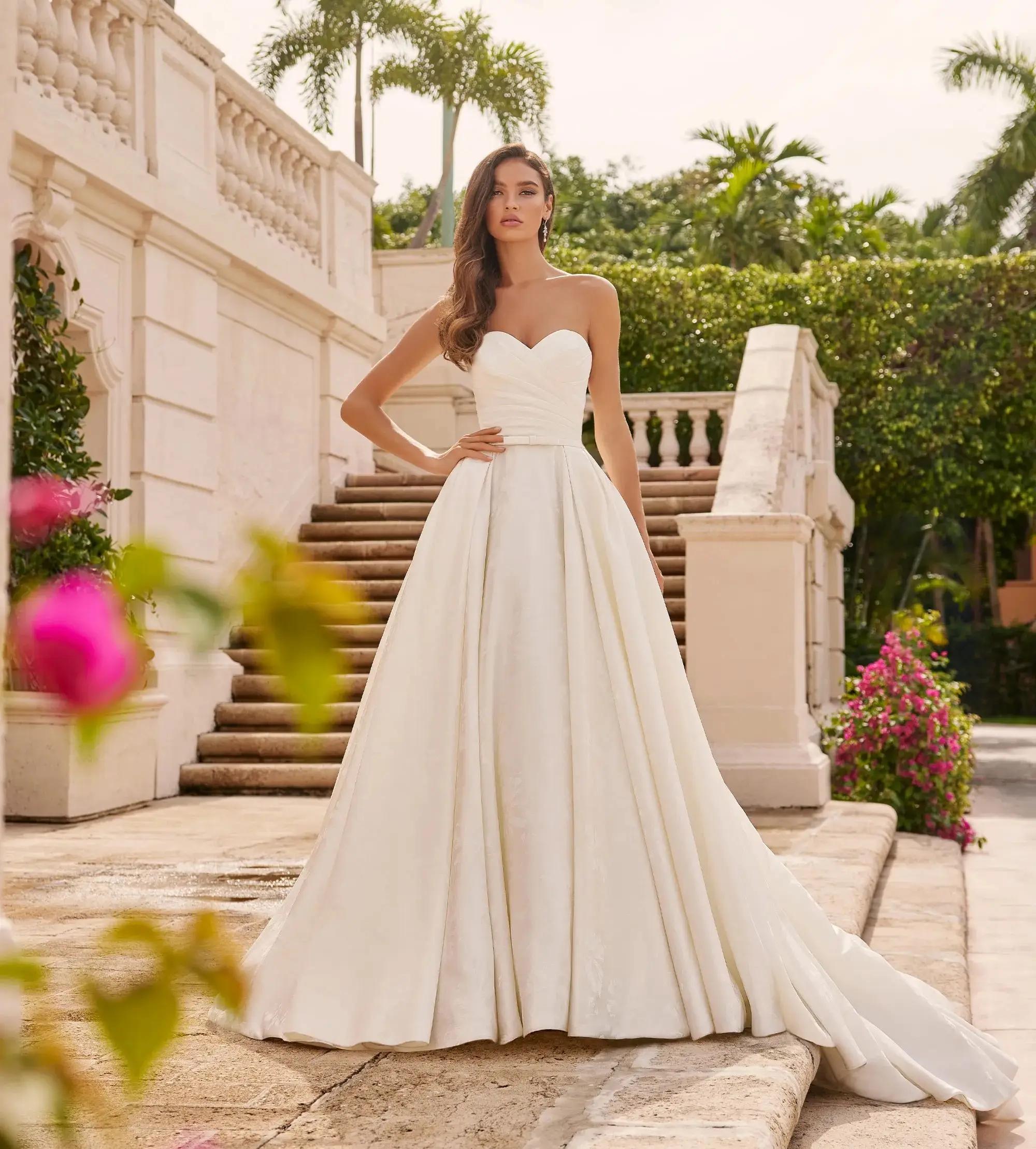 Blonde woman in ball style wedding gown with deep neckline