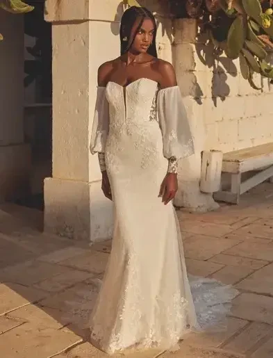 Woman with curly hair wearing boho V-Neck Tulle A-Line Bridal Dress with Sequined Lace Appliques