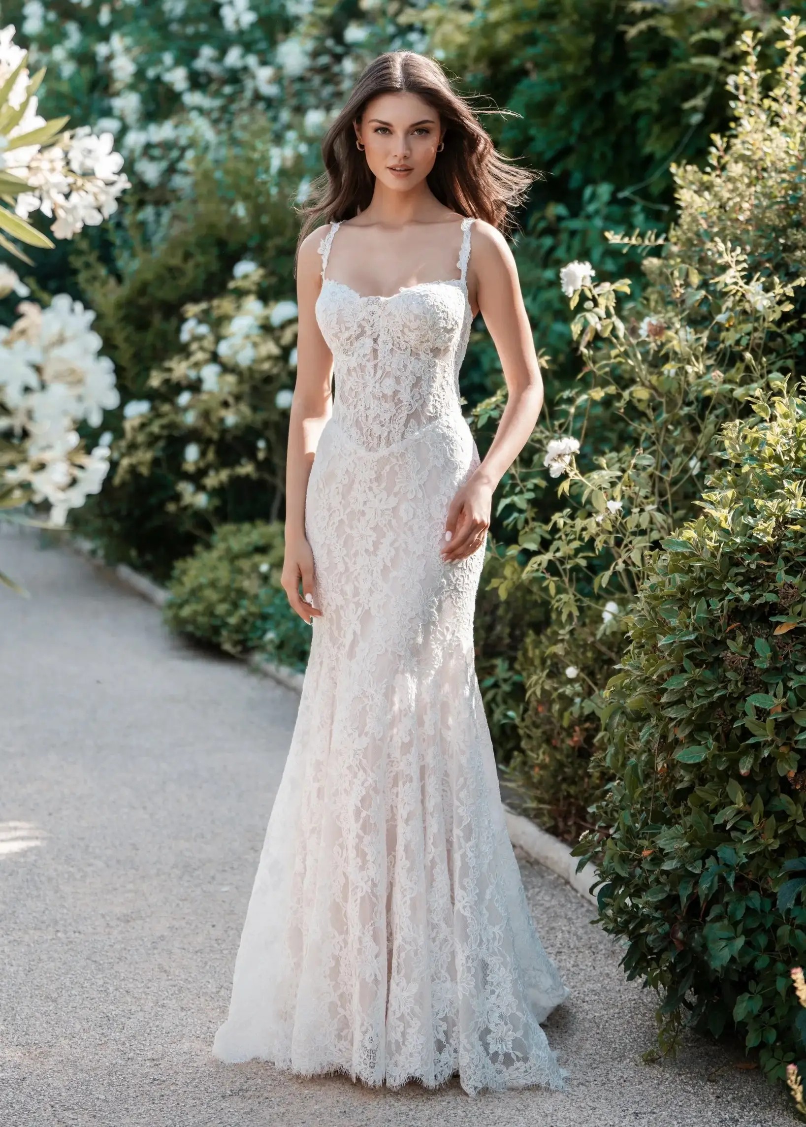 Brunette woman wearing a detachable stretch Mikado train wedding dress featuring a beautifully
