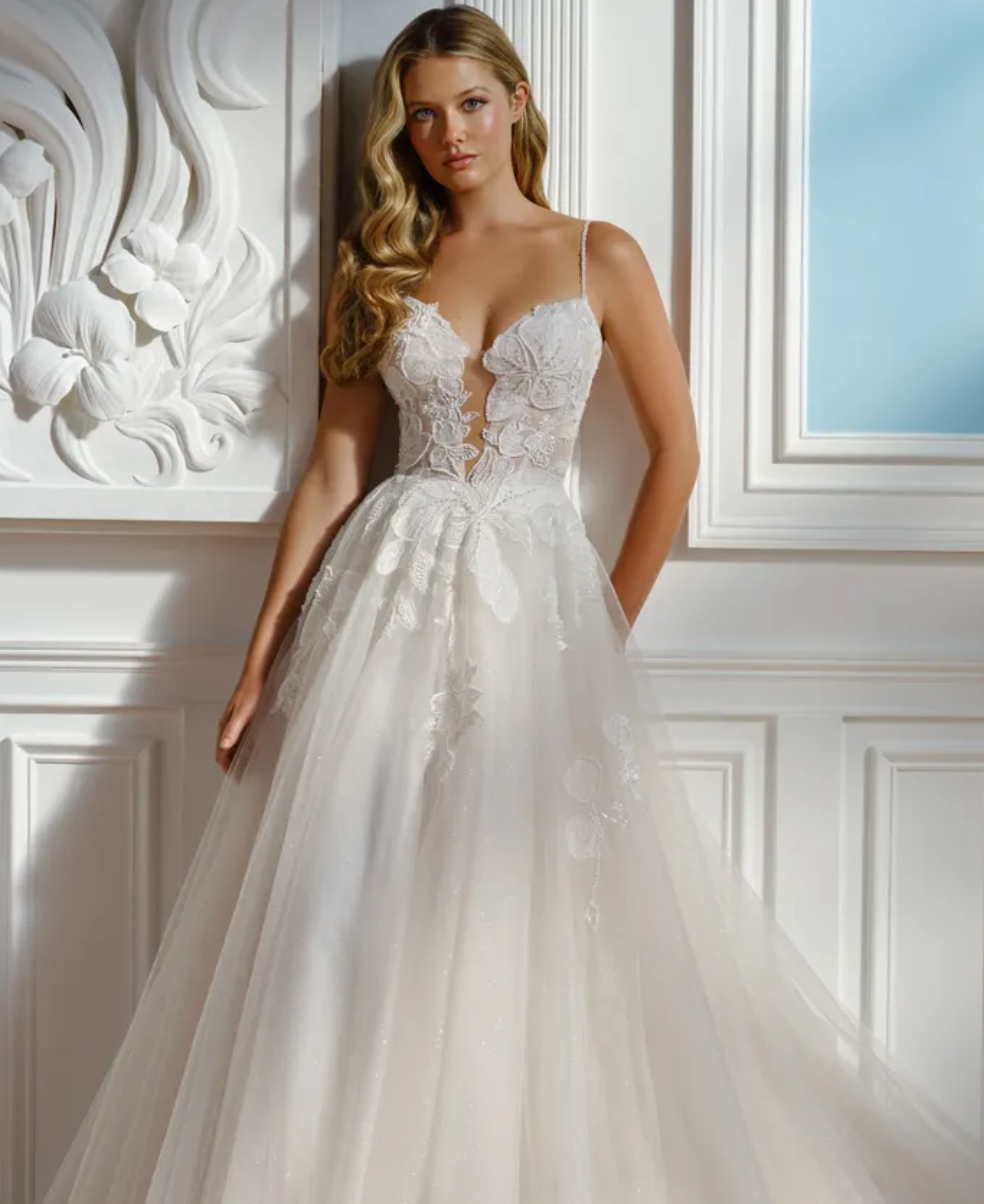 Blonde woman in ballgown, tulle & lace, wedding gown with deep neckline